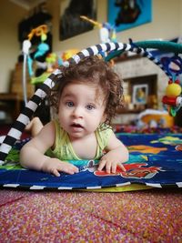 Portrait of cute baby boy lying at home