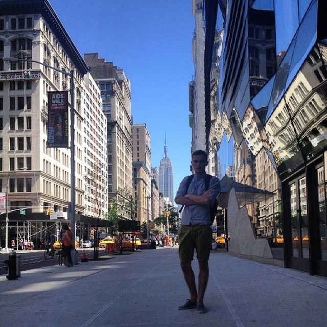 building exterior, architecture, built structure, city, walking, street, full length, rear view, men, city life, lifestyles, clear sky, the way forward, person, leisure activity, casual clothing, building, road