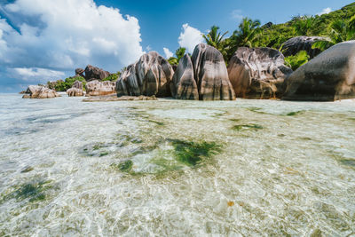 Rock formations by sea against sky