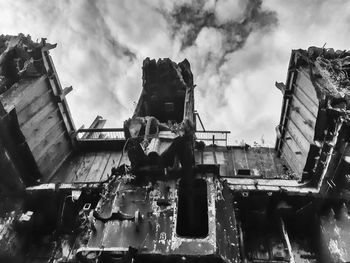 Low angle view of abandoned buildings against sky