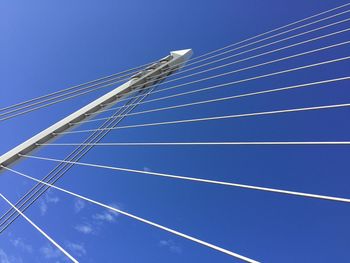 Low angle view of cables against blue sky