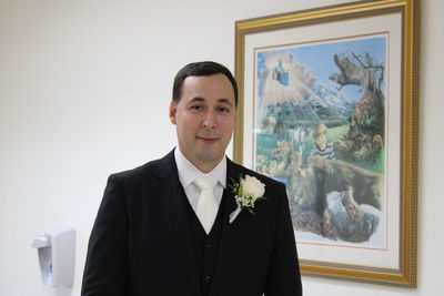 Portrait of businessman standing against white background