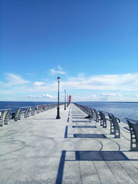 Footpath by sea against sky