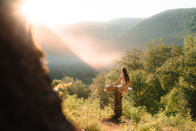 Side view of woman looking at mountain