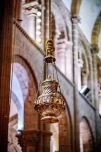 Low angle view of cross hanging in temple