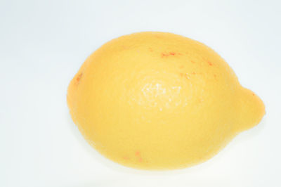Close-up of lemon against white background