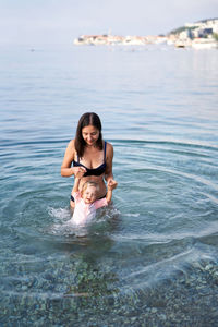 Young woman swimming in sea