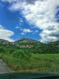 Scenic view of landscape against cloudy sky