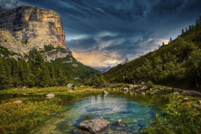 Scenic view of lake by mountains against sky