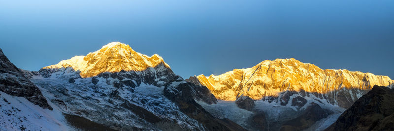 Scenic view of snowcapped mountains against clear sky