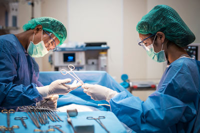 Surgeons operating patient in hospital