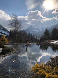 Scenic view of lake against sky during sunny day