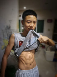Portrait of boy showing abs
