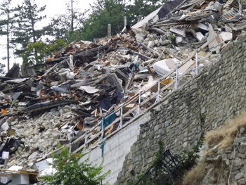 Low angle view of garbage amidst trees and building