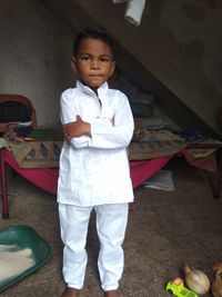 Portrait of cute boy standing at home