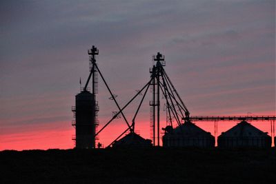 Silhouette of city against sky during sunset