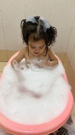 High angle view of girl in bathtub