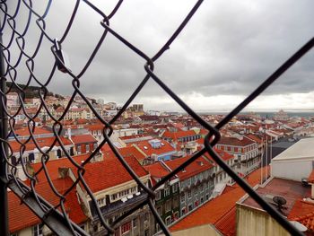 Cityscape seen through chainlink fence