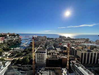High angle view of cityscape against clear blue sky