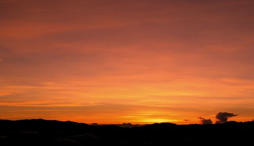 Silhouette landscape against scenic sky