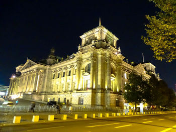 Low angle view of illuminated building at night