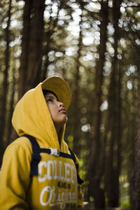 Boy in hood clothing at forest