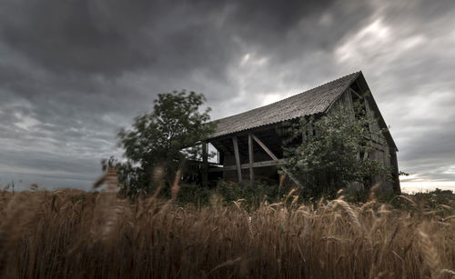 Abandoned built structure on field against sky