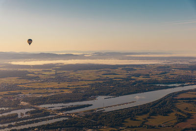 Aerial view of hot air balloon flying in sky