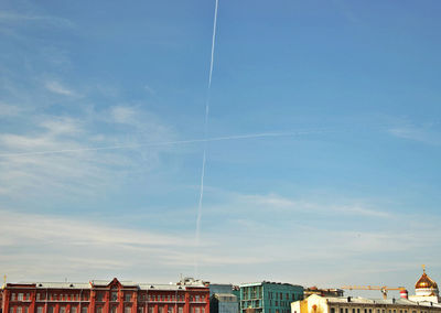 Low angle view of buildings against blue sky