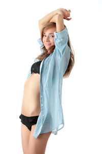 Midsection of woman standing against white background