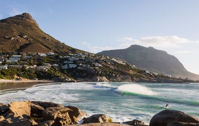 Scenic view of sea and mountains against sky