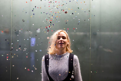 Portrait of beautiful woman behind glass window