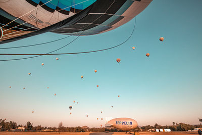 Low angle view of hot air balloon against blue sky