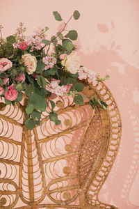 Close-up of flower vase on table against wall