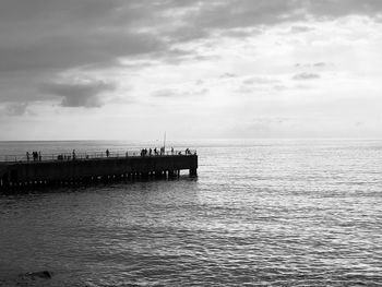 Pier over sea against sky