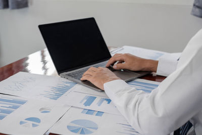 Midsection of businesswoman working at office