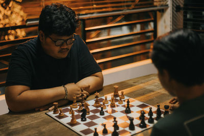 Man playing with chess in background