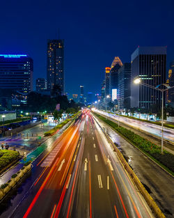 High angle view of light trails on road at night