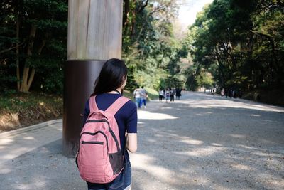 Rear view of woman walking on street in city