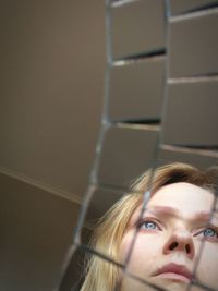 Close-up of thoughtful woman looking away reflecting on glass table