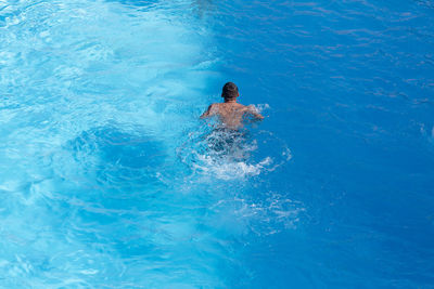 High angle view of man swimming in pool