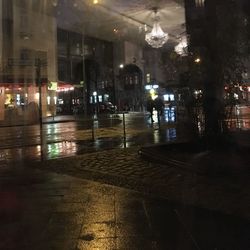 Wet illuminated city during rainy season