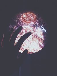 Close-up of hand holding illuminated light