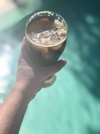 Close-up of hand holding glass of drink