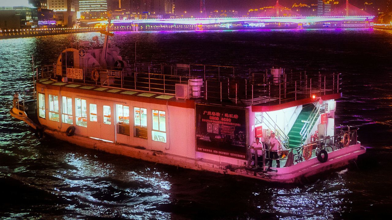 illuminated, architecture, built structure, night, building exterior, water, waterfront, city, river, long exposure, reflection, transportation, city life, travel destinations, motion, famous place, bridge - man made structure, outdoors, travel, capital cities