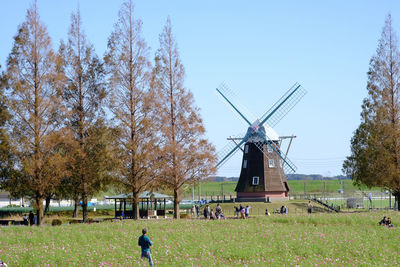 Traditional windmill on field against sky