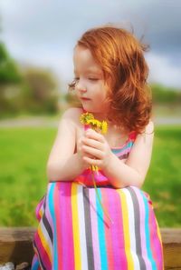 Portrait of young girl holding dandelions 