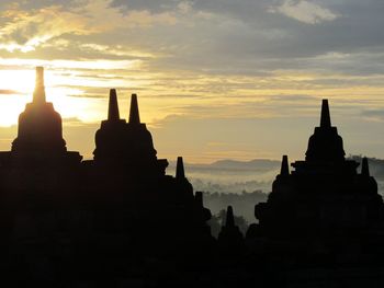 Silhouette temple against sky during sunset