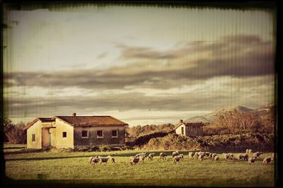 Built structure on landscape against cloudy sky