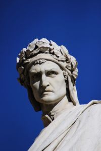 Low angle view of statue against clear blue sky